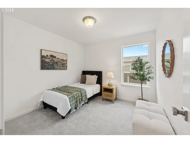 a spacious bedroom with a bed a couch and a window