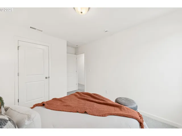 a bedroom with a bed and a lamp