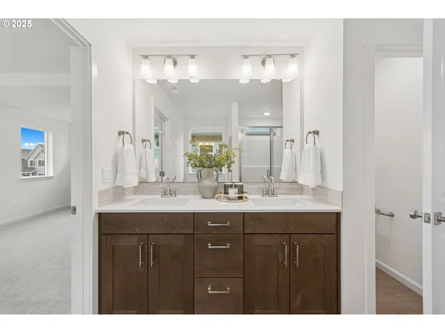 a bathroom with a granite countertop sink a large mirror a and a