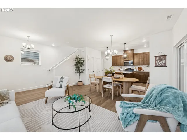 a living room with furniture and kitchen view