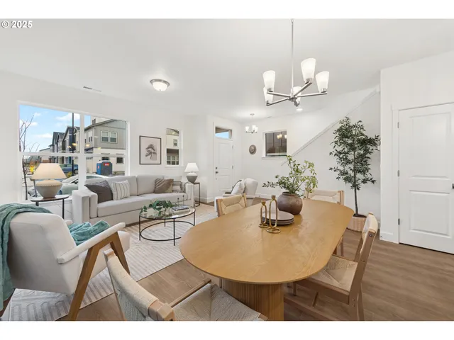 a dining room with furniture and wooden floor