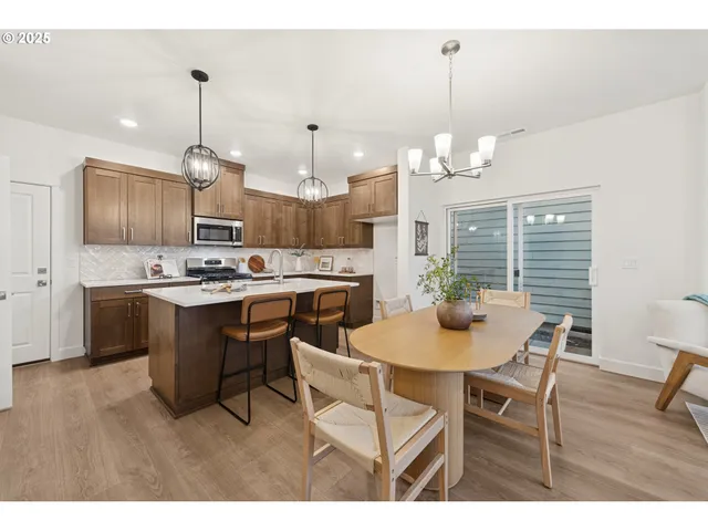 a kitchen that has a table and chairs in it