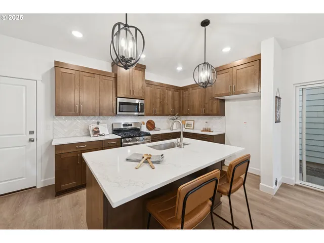 a kitchen with a sink refrigerator and cabinets