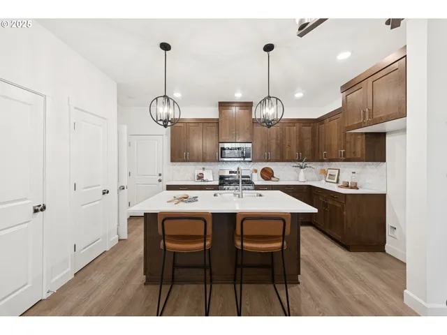 a kitchen with a sink center island and cabinets
