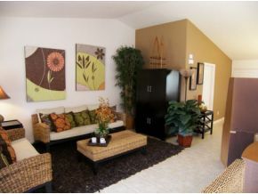 1010 Northeast Morgan Palm Bay, FL 32905 - Photo 2 of 12 a living room with furniture and a potted plant