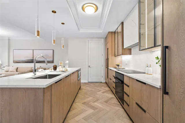 a kitchen with sink stove and cabinets