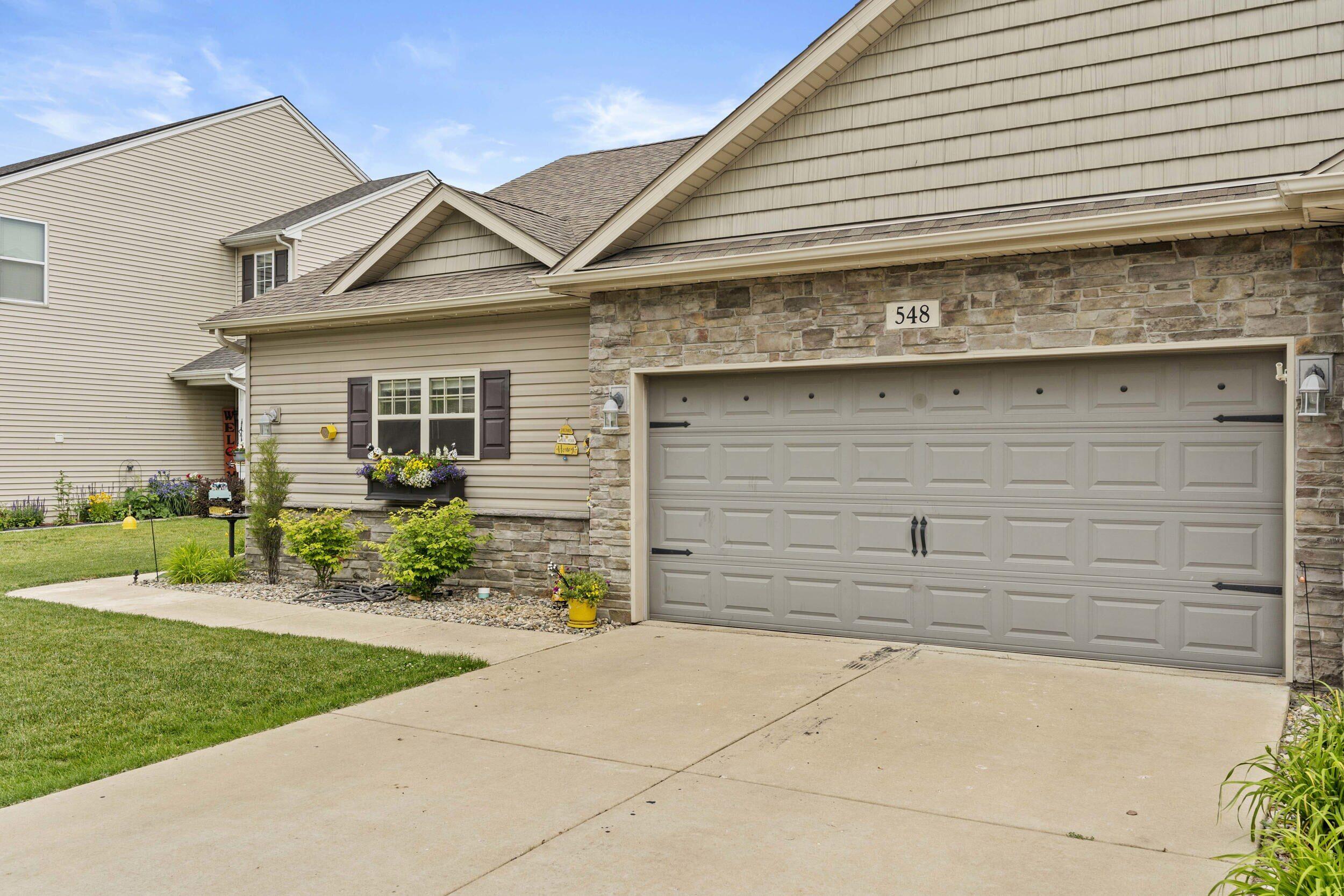 548 Aster Lane Griffith, IN 46319 - Photo 1 of 20 a front view of a house with a garden