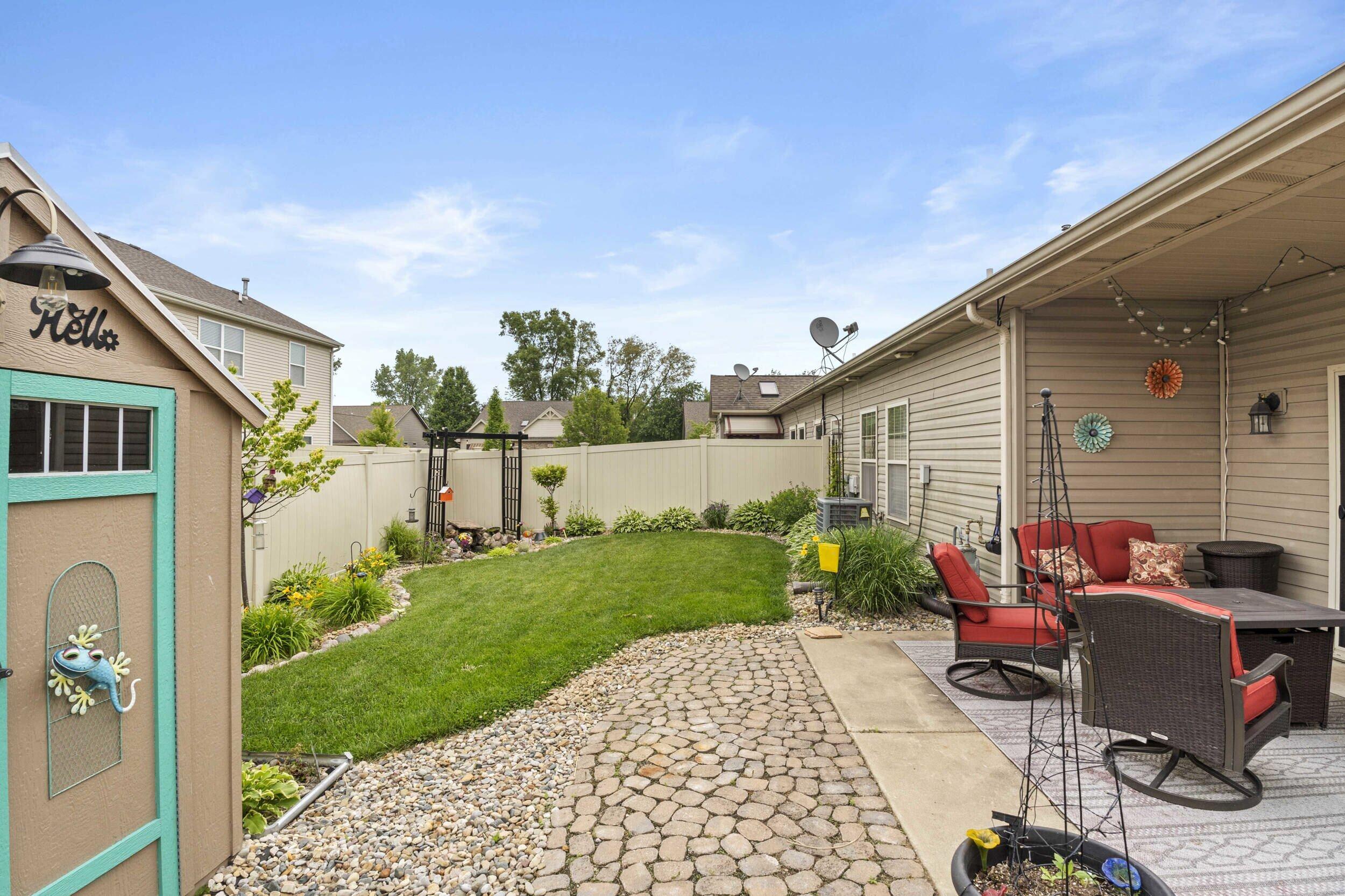 548 Aster Lane Griffith, IN 46319 - Photo 18 of 20 a view of a patio with chair and tables back yard of the house