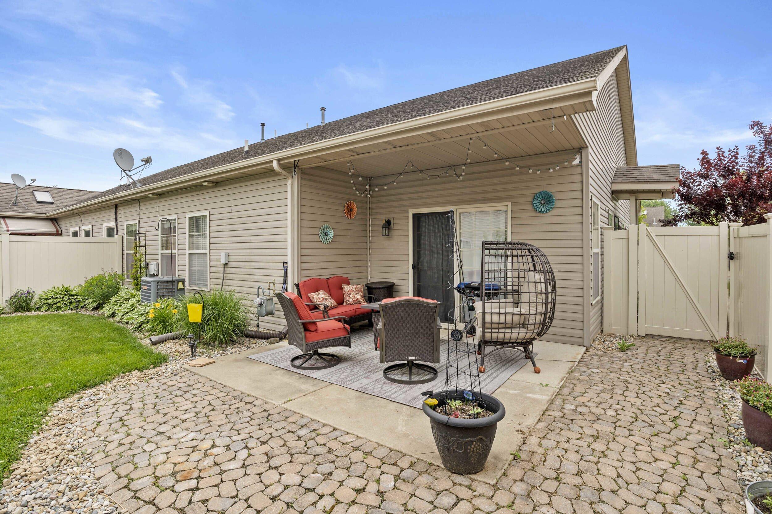 548 Aster Lane Griffith, IN 46319 - Photo 19 of 20 a view of a patio with table and chairs and potted plants
