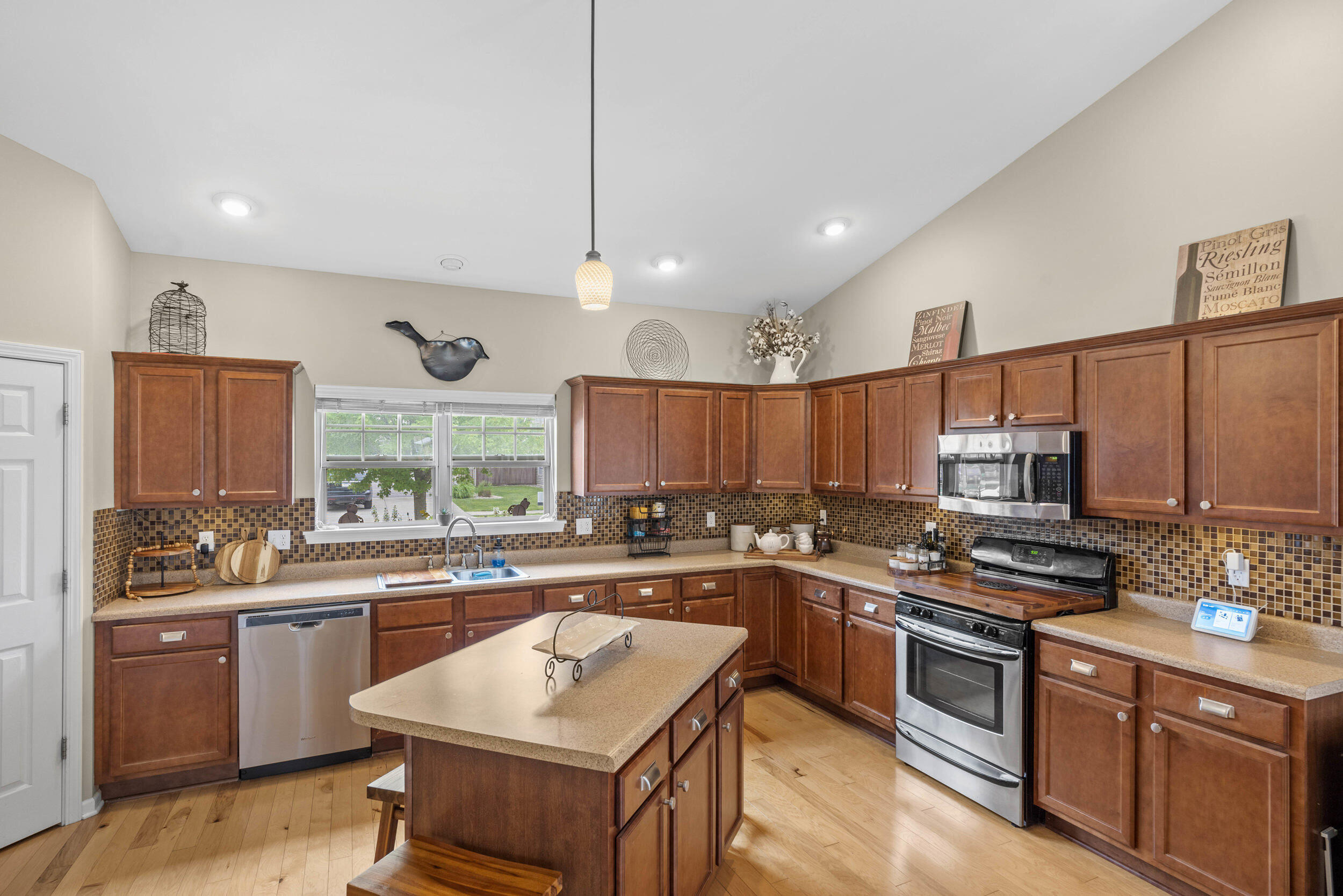 548 Aster Lane Griffith, IN 46319 - Photo 6 of 20 a kitchen with a sink stove top oven and microwave