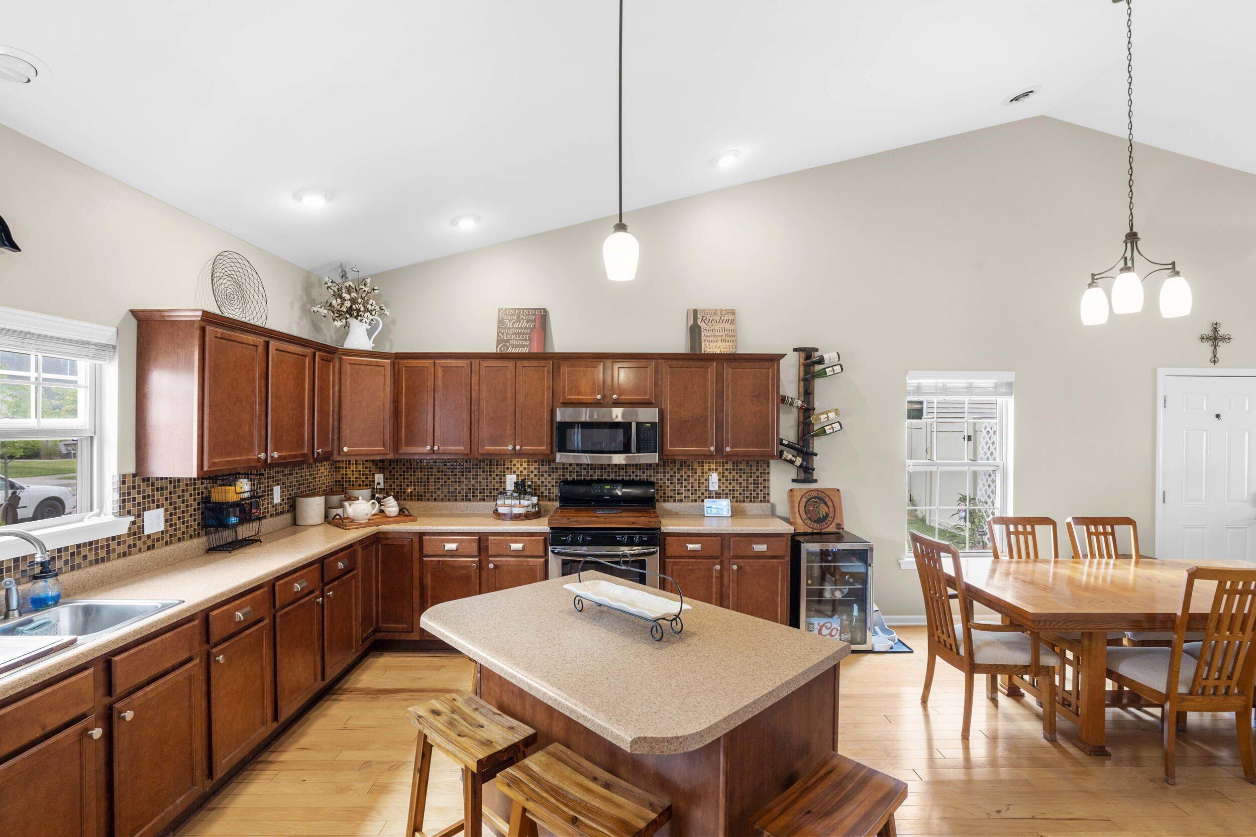 548 Aster Lane Griffith, IN 46319 - Photo 7 of 20 a kitchen with a sink a counter top space stainless steel appliances and a center island