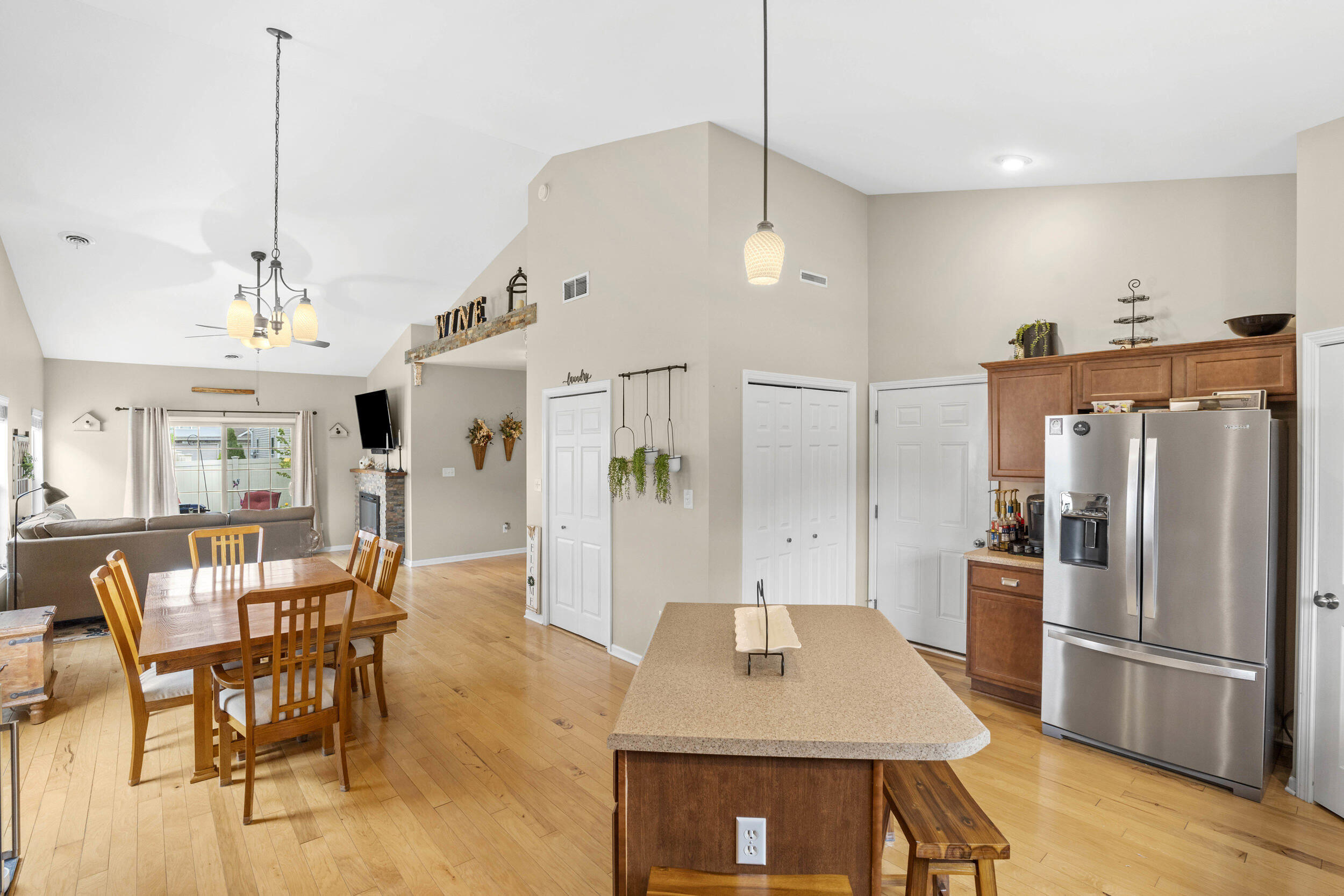 548 Aster Lane Griffith, IN 46319 - Photo 8 of 20 a open kitchen with stainless steel appliances granite countertop a stove a refrigerator a oven a sink a dining table and chairs with wooden floor