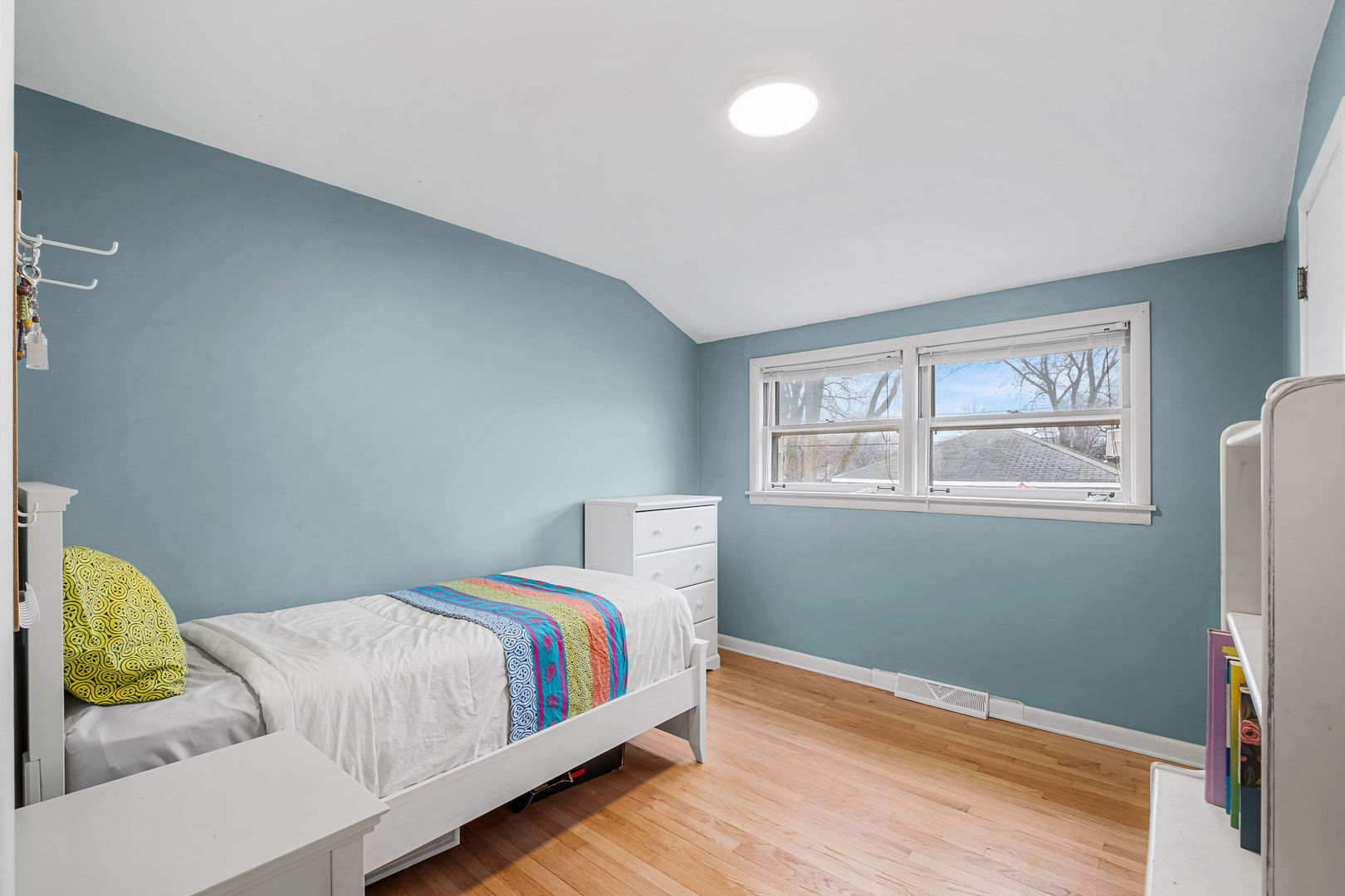 331 Romona Road Wilmette, IL 60091 - Photo 13 of 22 a bedroom with a bed and wooden floor
