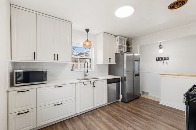 331 Romona Road Wilmette, IL 60091 - Photo 6 of 22 a kitchen with stainless steel appliances a refrigerator and a stove top oven