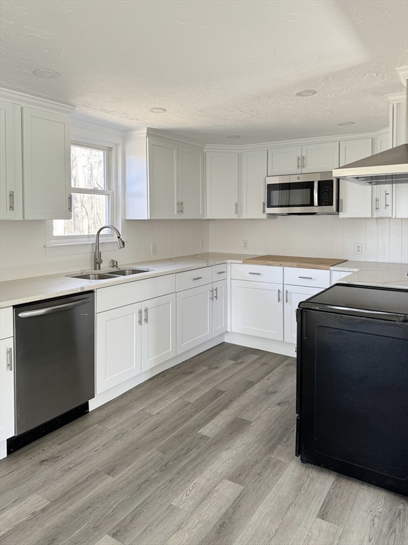 a kitchen with stainless steel appliances granite countertop a sink and cabinets