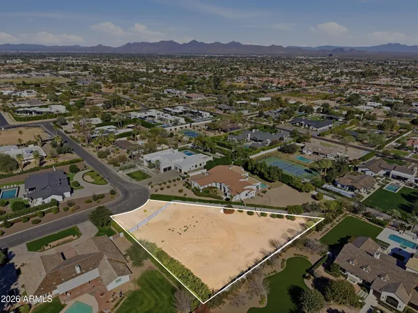 an aerial view of a house with garden space and street view