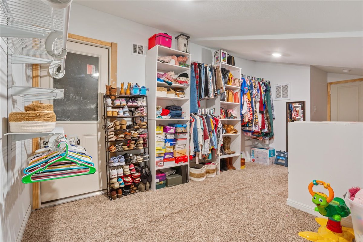 50 Dusty Dam Road Coupland, TX 78615 - Photo 16 of 38 The oversized walk-in closet offers generous space for clothing, shoes, and accessories, providing both organization and convenience within the primary suite.