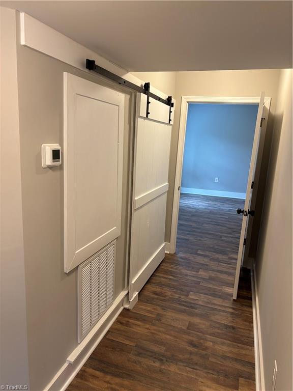1007 Haled Street Eden, NC 27288 - Photo 6 of 16 hallway to primary suite with access to laundry room with sliding barn door