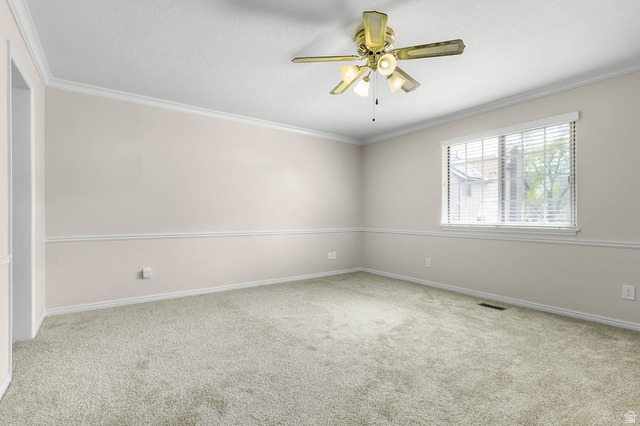 1822 East 9800th Street South Sandy, UT 84092 - Photo 23 of 38 Unfurnished room with carpet floors, ornamental molding, and ceiling fan