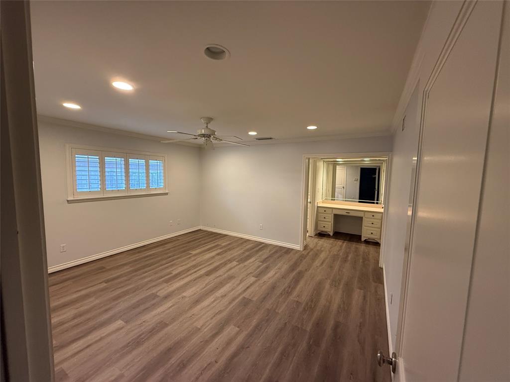 4916 Sugar Mill Road Dallas, TX 75244 - Photo 12 of 18 downstairs main bedroom with recessed lighting, ornamental molding, built in study area, dark wood-style flooring, and a ceiling fan