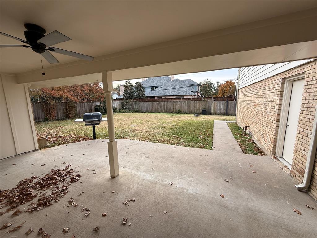 4916 Sugar Mill Road Dallas, TX 75244 - Photo 16 of 18 Fenced backyard with a patio area and ceiling fan