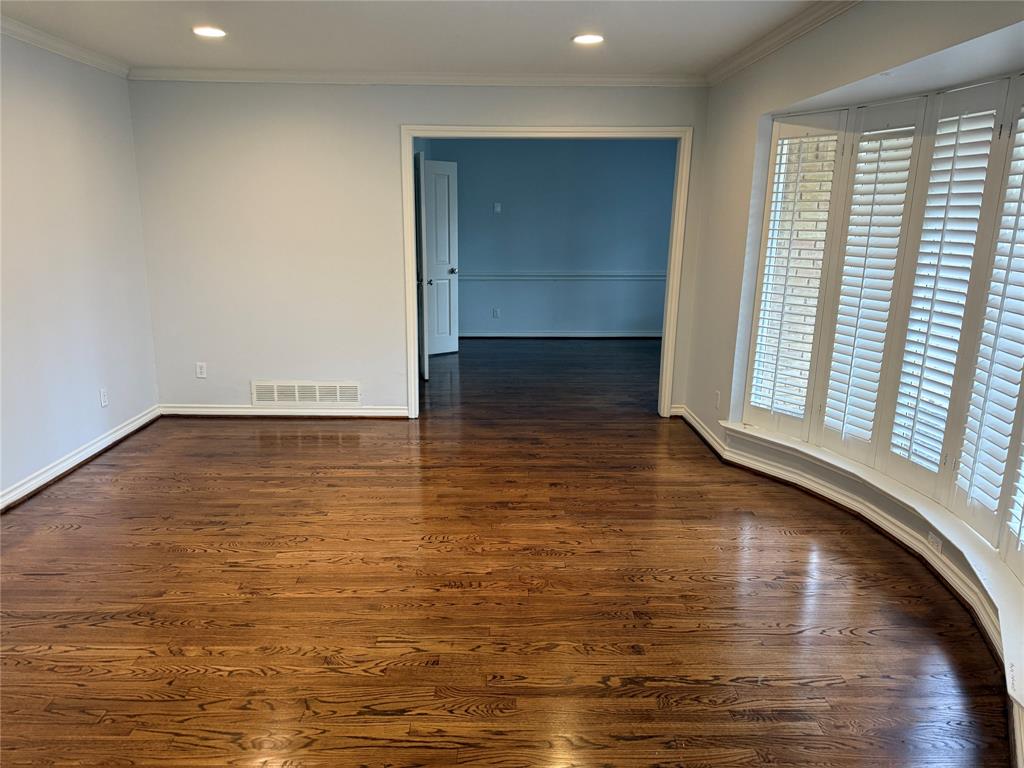 4916 Sugar Mill Road Dallas, TX 75244 - Photo 2 of 18 Unfurnished room featuring dark wood finished floors, crown molding, and recessed lighting