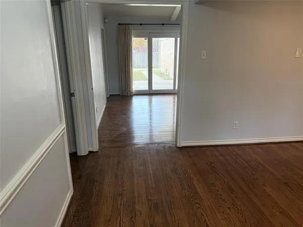 a view of wooden floor and windows in a room