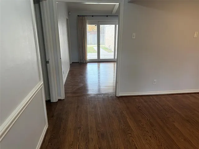 a view of wooden floor and windows in a room