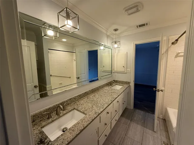 a bathroom with a granite countertop sink mirror and shower