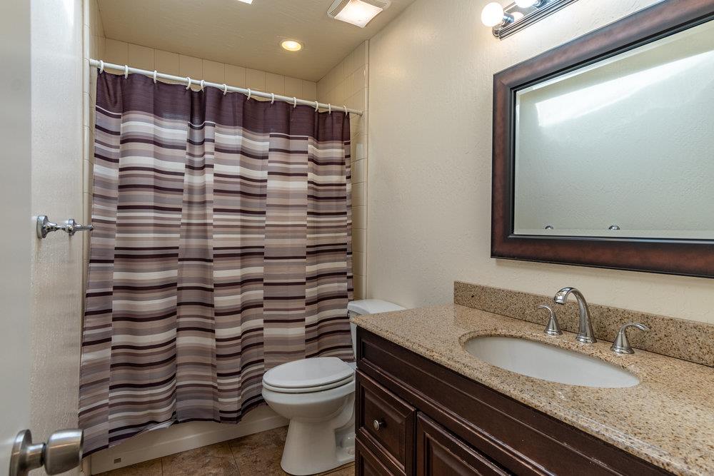 102 Smith Road Watsonville, CA 95076 - Photo 12 of 41 a bathroom with a granite countertop toilet sink and mirror