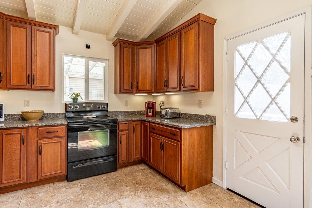 102 Smith Road Watsonville, CA 95076 - Photo 8 of 41 a kitchen with stainless steel appliances granite countertop a stove a sink dishwasher and a refrigerator