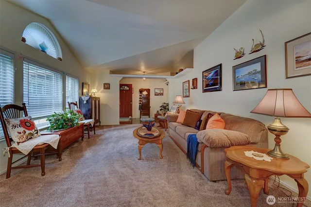 a living room with furniture a lamp and a large window