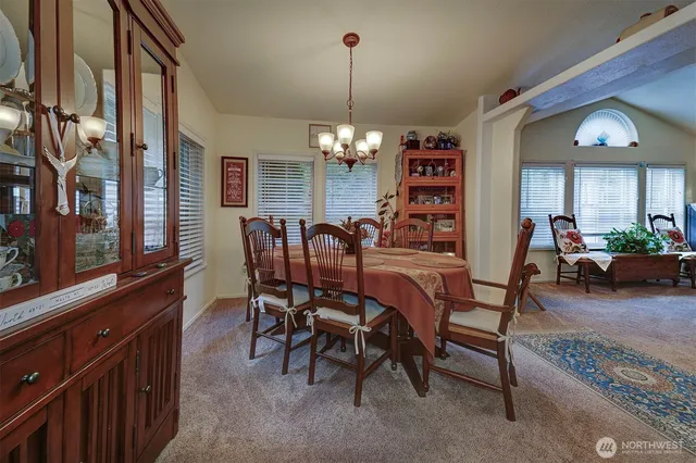 a view of a dining room with furniture and chandelier