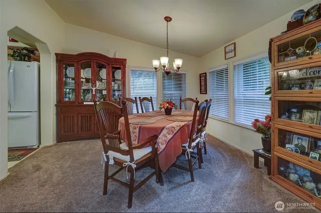 a dining room with furniture and chandelier