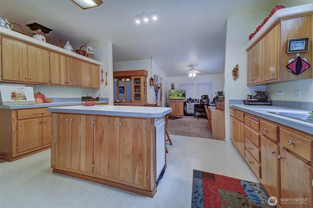 a kitchen with stainless steel appliances a sink a stove a refrigerator cabinets and a counter top space