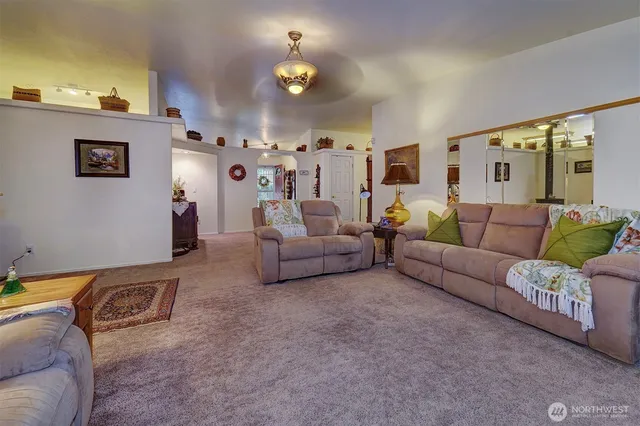 a living room with furniture and a chandelier