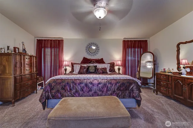 a bedroom with a bed window and dresser