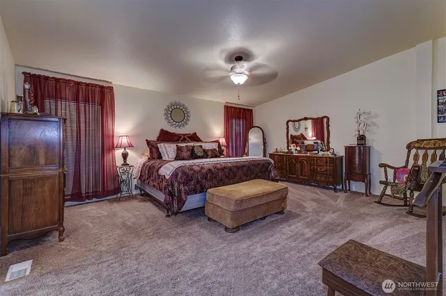 a bedroom with bed and a chandelier