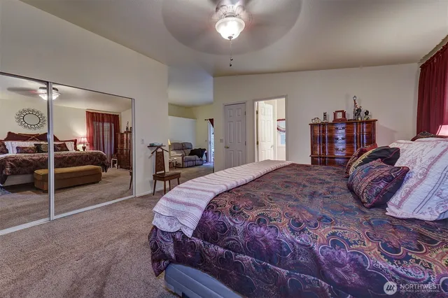 a bedroom with a large bed and a chandelier