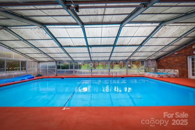 a room with pool table and a floor to ceiling window