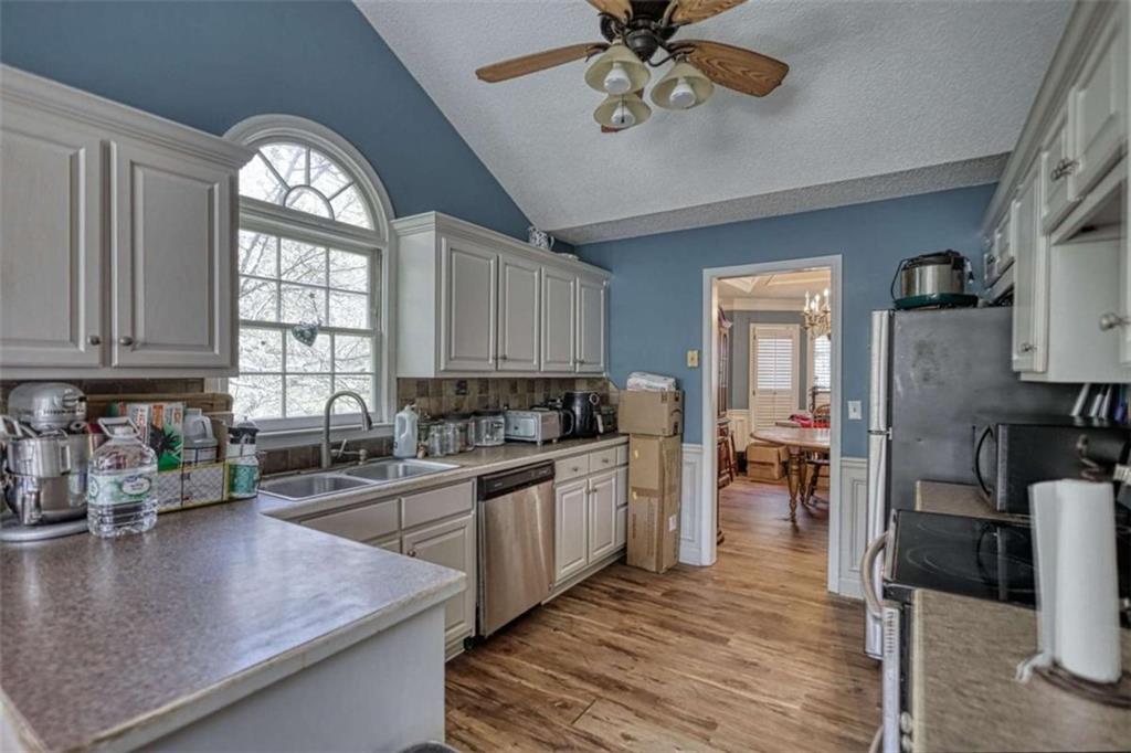 3588 Old Hamilton Mill Road Northeast Buford, GA 30519 - Photo 11 of 49 a kitchen with a large window appliances and cabinets