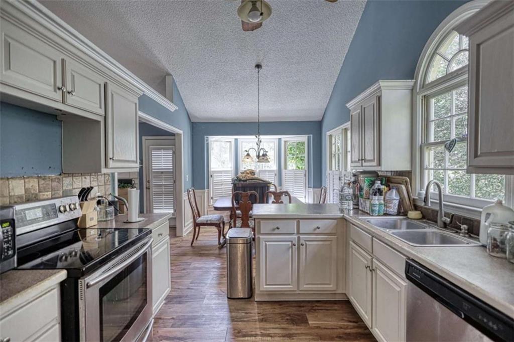 3588 Old Hamilton Mill Road Northeast Buford, GA 30519 - Photo 12 of 49 a kitchen with stainless steel appliances granite countertop a sink stove and cabinets