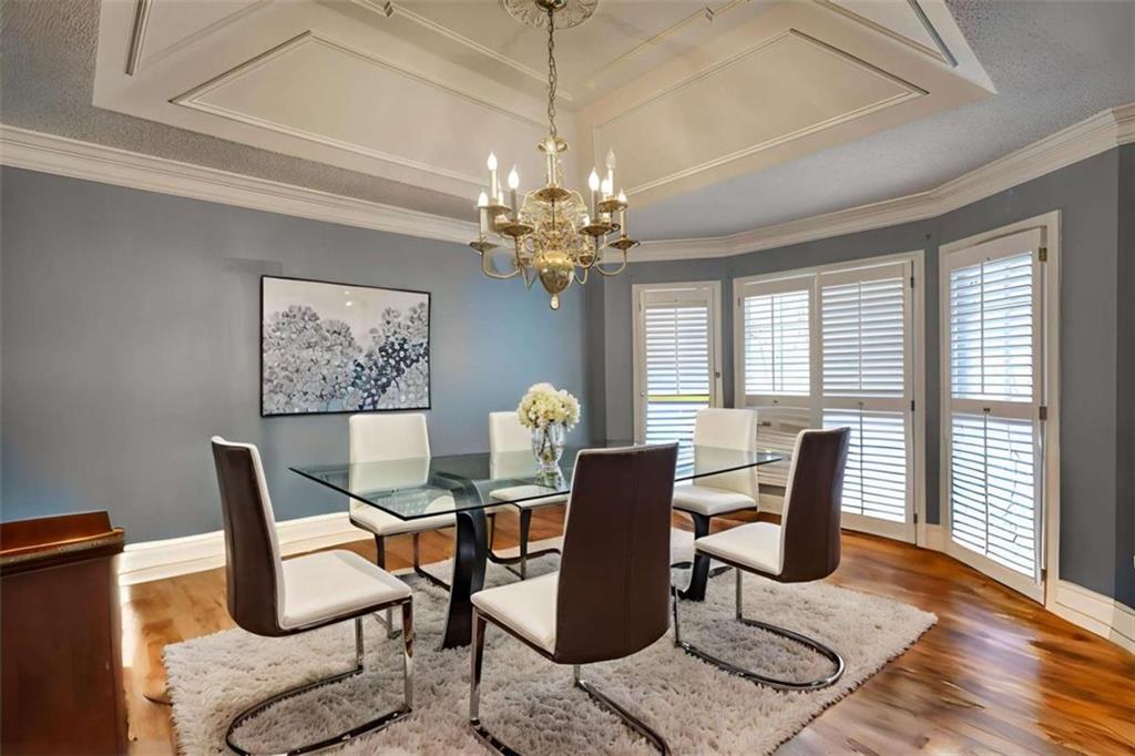 3588 Old Hamilton Mill Road Northeast Buford, GA 30519 - Photo 14 of 49 a dining room with furniture a chandelier and wooden floor