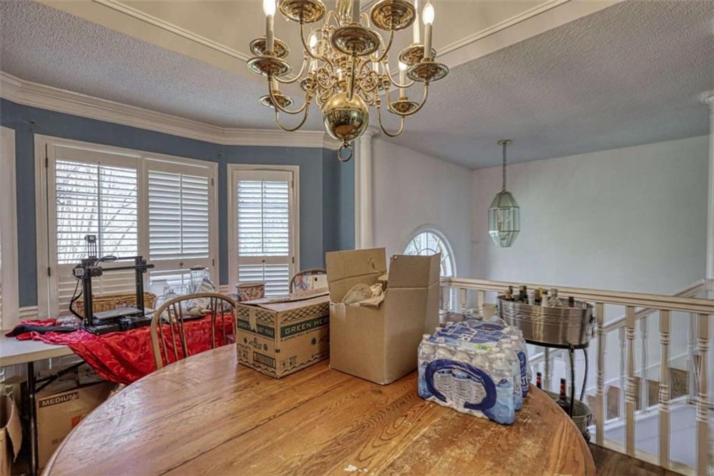 3588 Old Hamilton Mill Road Northeast Buford, GA 30519 - Photo 16 of 49 a living room with furniture and a chandelier