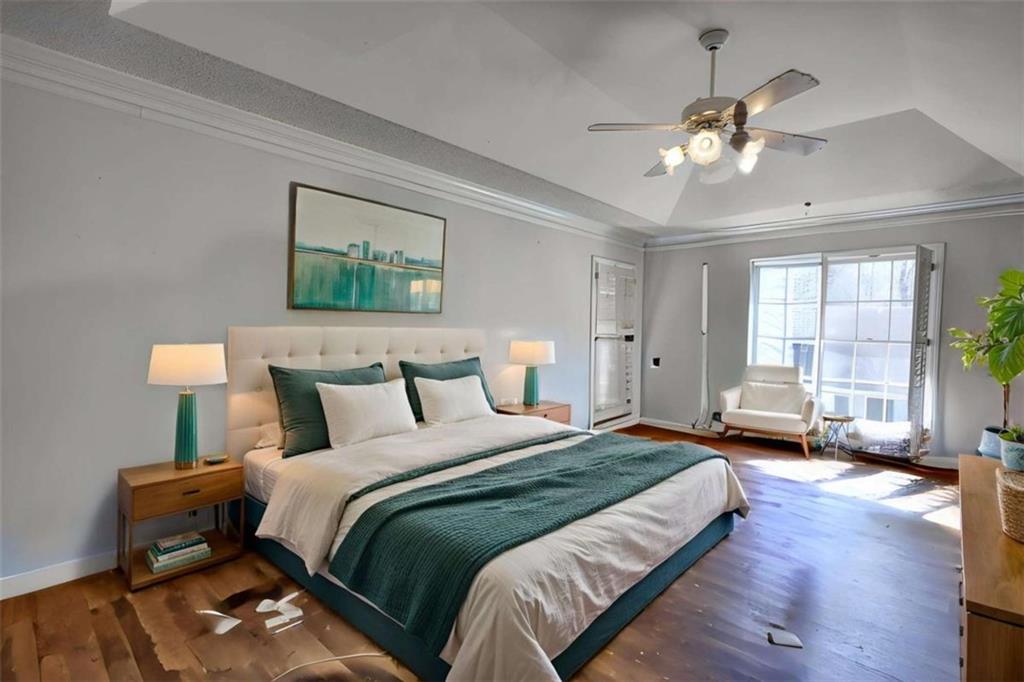 3588 Old Hamilton Mill Road Northeast Buford, GA 30519 - Photo 17 of 49 a spacious bedroom with a bed and a chandelier