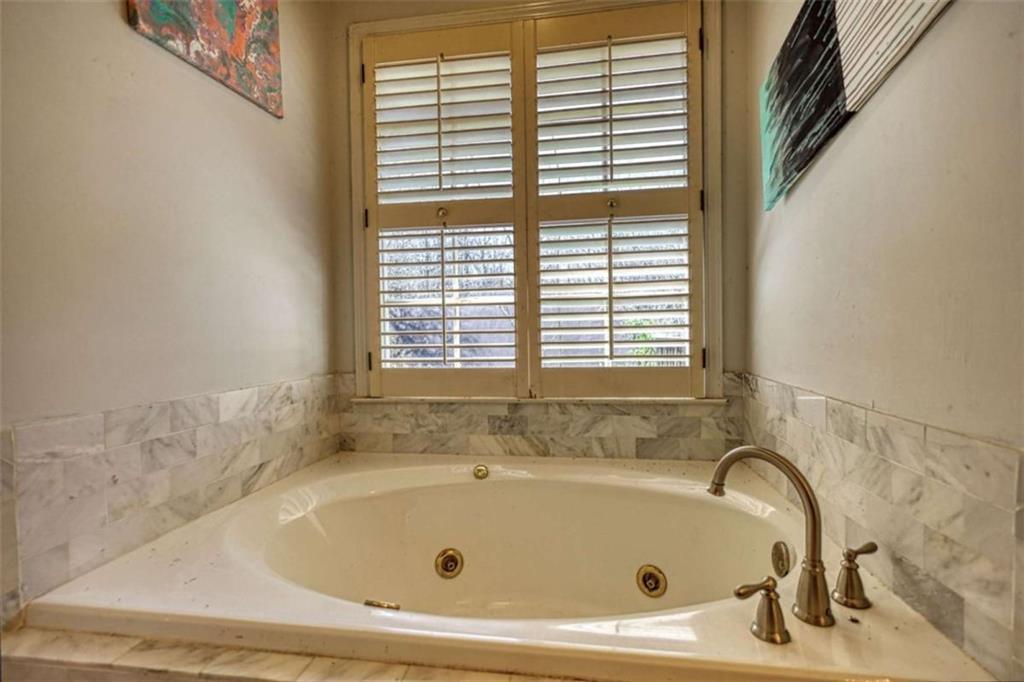 3588 Old Hamilton Mill Road Northeast Buford, GA 30519 - Photo 22 of 49 a bathroom with a tub and a window