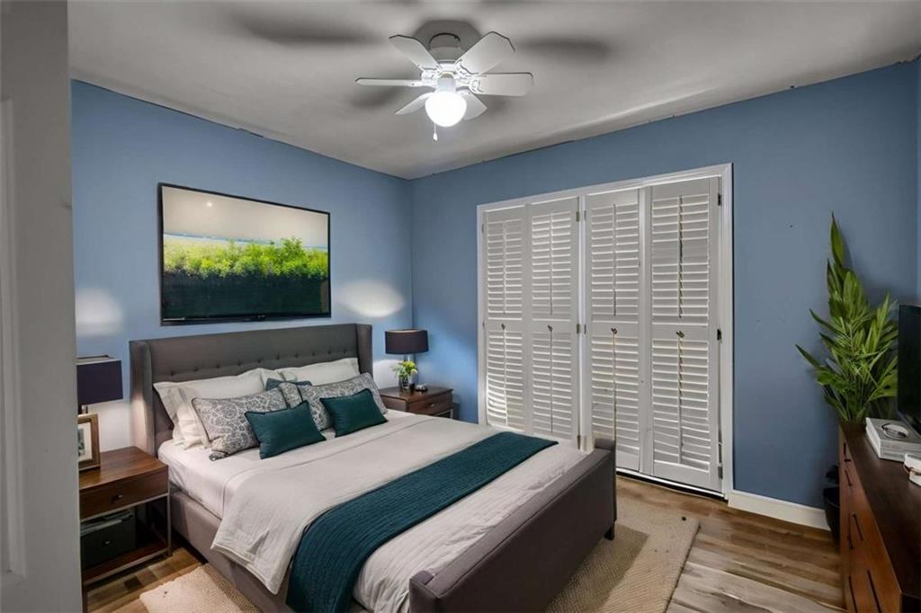 3588 Old Hamilton Mill Road Northeast Buford, GA 30519 - Photo 23 of 49 a bedroom with bed tv and a potted plant