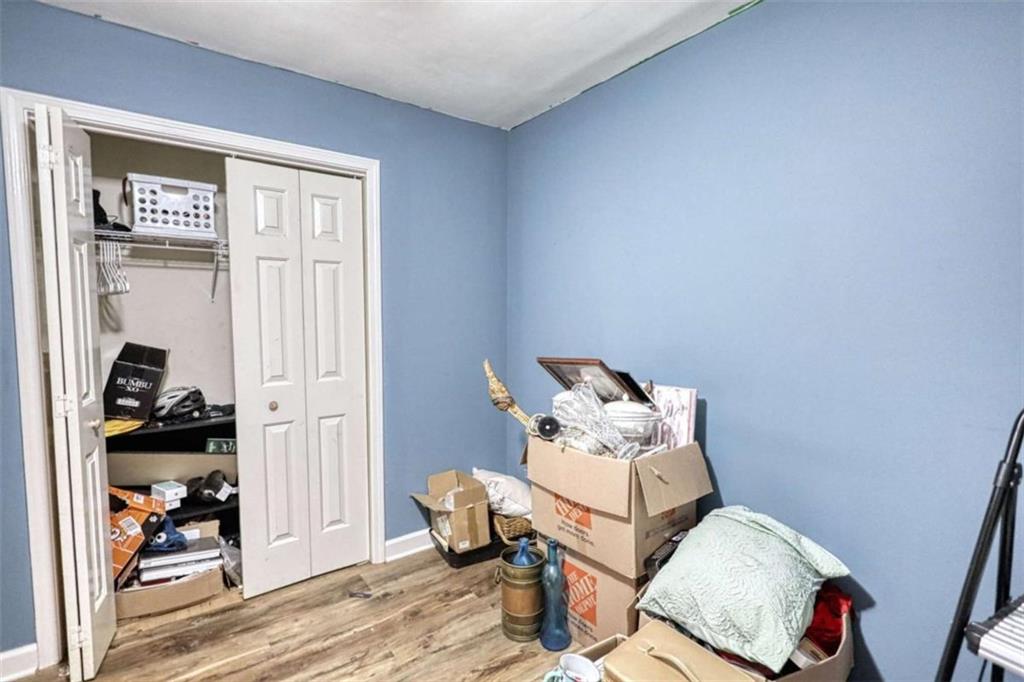 3588 Old Hamilton Mill Road Northeast Buford, GA 30519 - Photo 25 of 49 a bedroom with a bed and wooden floor