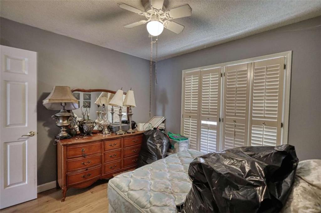 3588 Old Hamilton Mill Road Northeast Buford, GA 30519 - Photo 28 of 49 a bedroom with a bed and a chandelier