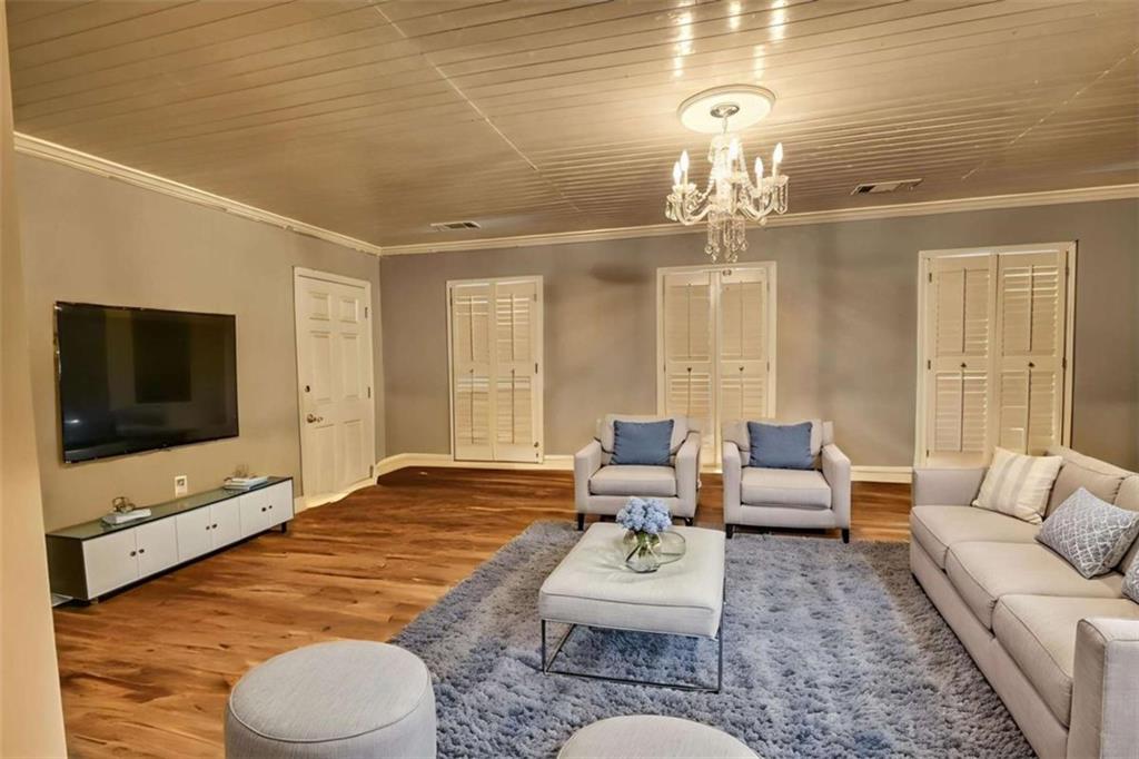 3588 Old Hamilton Mill Road Northeast Buford, GA 30519 - Photo 33 of 49 a living room with furniture and a flat screen tv